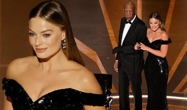 Margot Robbie puts on a busty display as she presents at the Oscars