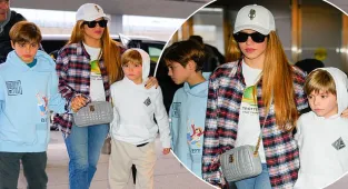 Shakira keeps sons Sasha and Milan close to her at airport