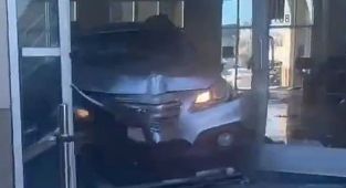 Moment deranged driver rams into car showroom injuring eight people
