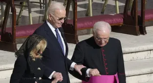 Biden grips priest and wife Jill as he arrives at Pope's funeral