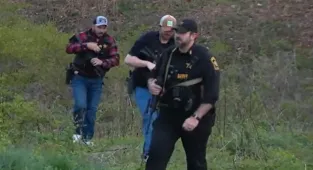 Hooded gunmen seen roaming Virginia streets before killing three