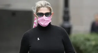 Politician's wife hides face as she's found GUILTY of bribery scheme