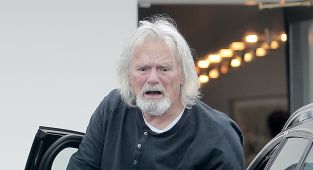 Reclusive former 80s heartthrob makes rare outing...can you guess who?