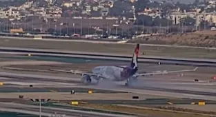 Smoke billows from Hawaiian Airlines plane as it prepares to take off