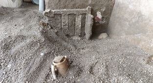 Archaeologists discover bed wedged against door of house in Pompeii