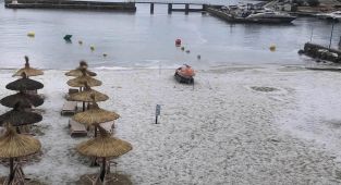 Majorca's beaches are turned white with ICE as freak storm hits
