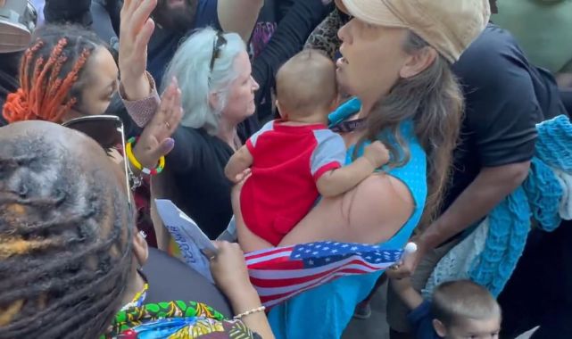 Moment trans mob surrounds Christian mother and her baby