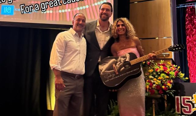 Travis Kelce poses with fans who bought Taylor Swift merch