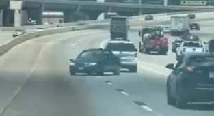 Video shows out-of-control Saab 'reversing' wrong way down busy road