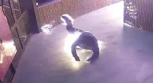 Wild moment alleged arsonist sets himself alight inside a restaurant