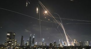 Israelis take cover in bomb shelters as Iran launches wave of missiles