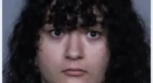 Masked flag-wielding trans protestor arrested for attacking activist
