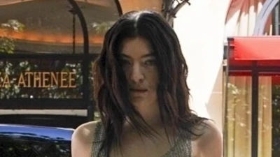 Braless Lorde covers modesty with black tape in a sheer chain dress