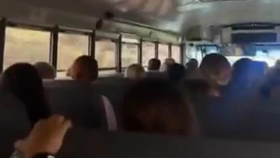 Bus full of campers sing before being confronted with terrifying sight