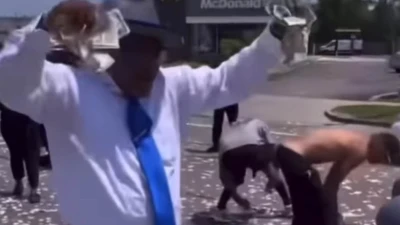Chaos in Detroit as dead man's fortune is dropped from helicopter