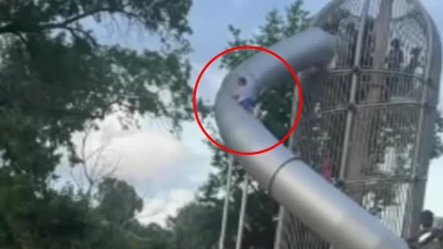 Horror after little boy climbs on OUTSIDE of slide and loses his grip