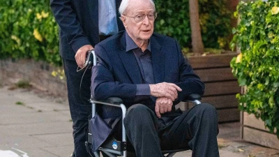 Michael Caine, 92, is pushed in a wheelchair by his friend Vin Diesel