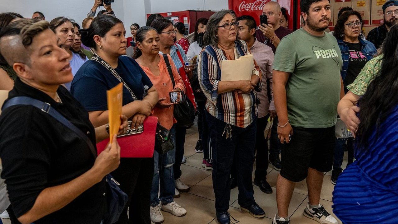 Outraged mob of grieving families demand answers over 400 corpses