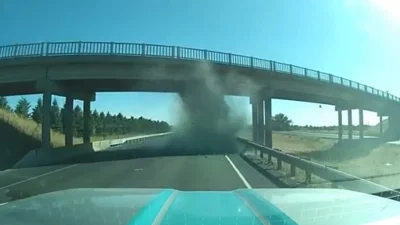 Incredible video shows trucker come within inches of backhoe death